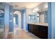 A bathroom featuring dual sinks, dark cabinetry and tiled floors at 12026 Medley Ter, Lakewood Ranch, FL 34211