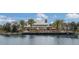 Lakeside clubhouse featuring a pier with seating, a pool and umbrellas at 12026 Medley Ter, Lakewood Ranch, FL 34211