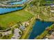Aerial view of a community park with a playground, baseball field, and a lake at 12026 Medley Ter, Lakewood Ranch, FL 34211