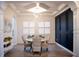 Bright dining room with plantation shutters, elegant lighting, and dark built-in cabinets at 12026 Medley Ter, Lakewood Ranch, FL 34211