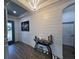 Stylish foyer featuring wood-paneled walls, modern decor, a beautiful chandelier, and hardwood floors at 12026 Medley Ter, Lakewood Ranch, FL 34211
