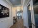 Hallway featuring modern wall decor and beautiful hardwood floors; stylish lighting enhances the space at 12026 Medley Ter, Lakewood Ranch, FL 34211