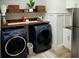 A laundry room with a front load washer and dryer, shelving and stainless steel refrigerator at 12026 Medley Ter, Lakewood Ranch, FL 34211