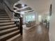 Bright living room with staircase, hardwood floors, coffered ceiling and view to outdoor living at 12026 Medley Ter, Lakewood Ranch, FL 34211