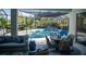 Comfortable outdoor sitting area with a pool view, bar and seating, table and chairs at 12026 Medley Ter, Lakewood Ranch, FL 34211
