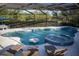 Resort style screened in pool with a hot tub, sun shelf, and swim up table at 12026 Medley Ter, Lakewood Ranch, FL 34211