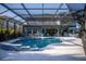 A beautiful backyard pool and spa with a screened enclosure and outdoor dining area at 12026 Medley Ter, Lakewood Ranch, FL 34211