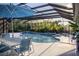 Enclosed pool area with seating, water features, and a beautiful view of lush greenery at 12026 Medley Ter, Lakewood Ranch, FL 34211