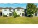 The backyard has green grass, a small patio and privacy hedges at 1227 Ballard Green Pl, Brandon, FL 33511