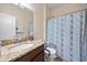 Bathroom showcasing granite countertops, a single sink, and blue floral shower curtain at 1227 Ballard Green Pl, Brandon, FL 33511