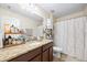 Bathroom featuring granite countertops, single sink, and a shower with floral curtain at 1227 Ballard Green Pl, Brandon, FL 33511