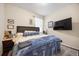 Bedroom featuring a large upholstered headboard and a mounted flatscreen television at 1227 Ballard Green Pl, Brandon, FL 33511