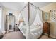 Bedroom features a canopy bed, matching nightstand and a mirror with flower detail at 1227 Ballard Green Pl, Brandon, FL 33511