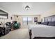 Spacious bedroom featuring a large bed, workspace, and natural light at 1227 Ballard Green Pl, Brandon, FL 33511