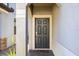 Close-up of a covered front door with a brick walkway, complemented by stucco siding and manicured landscaping at 1227 Ballard Green Pl, Brandon, FL 33511