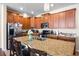 Spacious kitchen with wooden cabinets, stainless steel appliances, granite countertops, and a center island with seating at 1227 Ballard Green Pl, Brandon, FL 33511