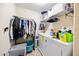Laundry room featuring washer and dryer, storage shelves, and hanging rack at 1227 Ballard Green Pl, Brandon, FL 33511