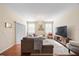 Bright living room featuring a large sectional sofa, hardwood floors, and a chandelier at 1227 Ballard Green Pl, Brandon, FL 33511