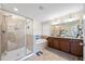 A luxurious main bathroom with a glass-enclosed shower and a soaking tub at 1227 Ballard Green Pl, Brandon, FL 33511