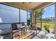 This screened patio offers comfortable seating and views of the lake at 1227 Ballard Green Pl, Brandon, FL 33511
