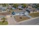 Aerial view of a residential home with a fenced backyard and a swimming pool in the neighborhood at 1264 Chelsea Ln, Holiday, FL 34691