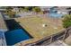 This back yard is enclosed by fencing and has a patio with above ground pool at 1264 Chelsea Ln, Holiday, FL 34691