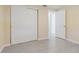 Cozy bedroom with gray tile flooring, a closet with sliding doors, and neutral paint at 1264 Chelsea Ln, Holiday, FL 34691