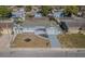 Aerial view of this house and yard including a driveway and landscaping at 1264 Chelsea Ln, Holiday, FL 34691
