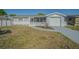 Charming single-story home with a screened-in porch and an attached garage with driveway at 1264 Chelsea Ln, Holiday, FL 34691