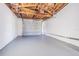 This garage offers high ceilings with exposed rafters and a finished floor at 1264 Chelsea Ln, Holiday, FL 34691