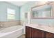 Bright bathroom featuring dual sink vanity, soaking tub, and a separate glass door shower at 12719 Saulston Pl, Hudson, FL 34669