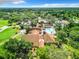 Aerial view of the community clubhouse, pool, tennis courts, and landscaping at 12920 Wedgewood Way # A, Hudson, FL 34667