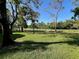 Picturesque green backyard landscape featuring beautiful lawn and mature trees at 12920 Wedgewood Way # A, Hudson, FL 34667