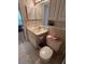 Cozy bathroom features a single sink vanity, toilet, with shutter cabinet and access to the bedroom at 12920 Wedgewood Way # A, Hudson, FL 34667
