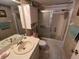 Cozy bathroom features a single sink vanity, toilet, and a shower/tub combo with sliding glass doors at 12920 Wedgewood Way # A, Hudson, FL 34667