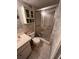 Cozy bathroom with white cabinets, toilet, and a glass enclosed shower at 12920 Wedgewood Way # A, Hudson, FL 34667