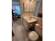 Cozy bathroom features a single sink vanity, toilet, with shutter cabinet and access to the bedroom at 12920 Wedgewood Way # A, Hudson, FL 34667