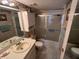 Cozy bathroom features a single sink vanity, toilet, and a shower/tub combo with sliding glass doors at 12920 Wedgewood Way # A, Hudson, FL 34667