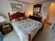 Warm bedroom features a wood-framed bed and matching dresser and nightstand at 12920 Wedgewood Way # A, Hudson, FL 34667