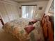 Warm bedroom features a wood-framed bed and closet with louvered doors at 12920 Wedgewood Way # A, Hudson, FL 34667