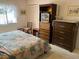 Bedroom with a large bed and adjacent dresser and entertainment center at 12920 Wedgewood Way # A, Hudson, FL 34667