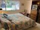 Bedroom with a large bed and adjacent dresser and entertainment center at 12920 Wedgewood Way # A, Hudson, FL 34667