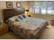 Bedroom with a large bed, wood headboard and side table with lamp at 12920 Wedgewood Way # A, Hudson, FL 34667