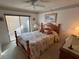 Warm bedroom features a wood-framed bed and ceiling fan at 12920 Wedgewood Way # A, Hudson, FL 34667