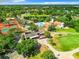 Aerial view of neighborhood, including the tennis courts, pool, and clubhouse with lush landscaping at 12920 Wedgewood Way # A, Hudson, FL 34667
