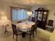 Traditional dining room features a chandelier, china cabinet and six-chair dining set at 12920 Wedgewood Way # A, Hudson, FL 34667