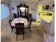 Traditional dining room features a chandelier, china cabinet and six-chair dining set at 12920 Wedgewood Way # A, Hudson, FL 34667