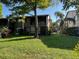 Two-story condo building with green lawn, shade tree and partial palm trees at 12920 Wedgewood Way # A, Hudson, FL 34667