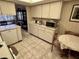 Well-lit kitchen with white appliances, tiled floor, and breakfast area at 12920 Wedgewood Way # A, Hudson, FL 34667