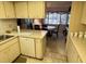 Open kitchen layout with view into dining area, featuring modern appliances at 12920 Wedgewood Way # A, Hudson, FL 34667